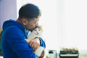 Man with cute cat . Pets and humans friendship, love and trust concept