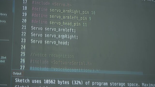 Close-up of a monitor showing Arduino IDE code with speech command function for a robotics or IoT programming project.