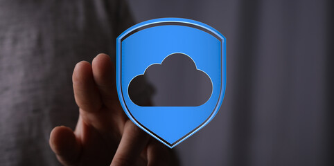 Hand holding a cloud icon inside a shield, representing secure cloud storage and data protection. Ideal for tec