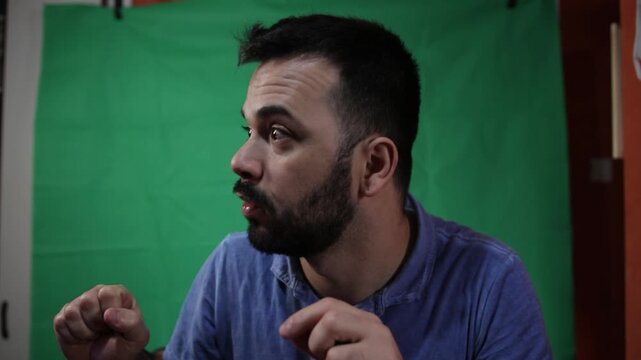 Man explaining or talking in front of a chroma key background.