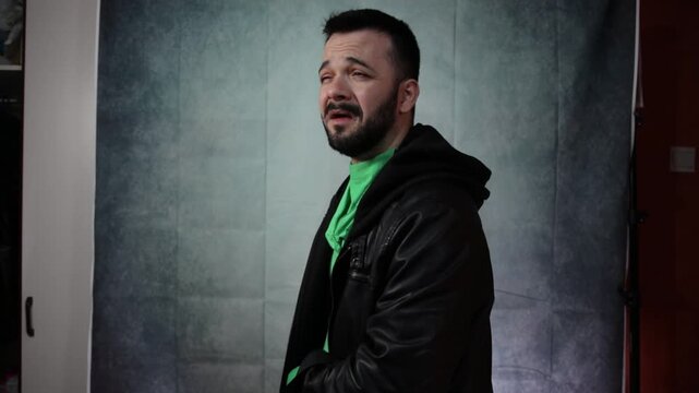 Side profile of a man on a chroma key green background.