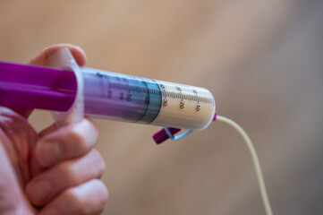 Fototapeta premium Medical syringe with tube feeding consisting of special milk for children who cannot eat.