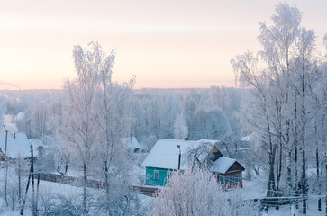 frosty winter village at pastel dawn