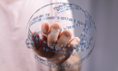 Abstract image of a hand interacting with a digital sphere of code, representing technology, internet, and data. Modern concept for d