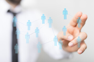 Close-up of a hand interacting with a network concept on a touchscreen, symbolizing global connection and business communication.