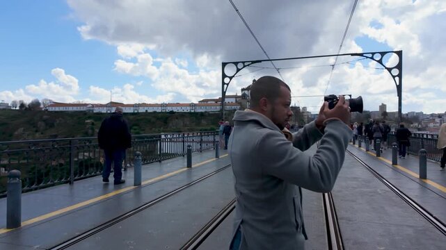 Man photographing city on Dom Luis I Bridge
Person taking pictures while standing on the iconic bridge in Porto.