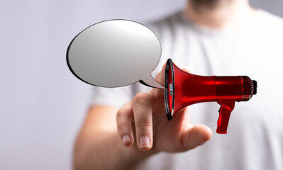 Person holding megaphone with message bubble. Concept of announcement, communication, advertising, and sharing ideas. Symbol of speech, alert, a