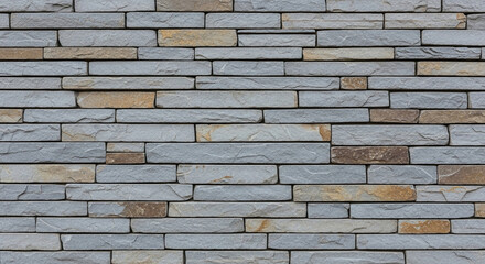 Obraz premium Grey and beige stone brick wall texture, showing a rough surface and subtle color variations. Represents strength, durability, and architectural design, suitable for construction or home decor