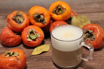persimmons, orange sharons, autumn fruits, fruits full of vitamins, ripe fruits, cup of cappuccino, autumn coffee with sharon
