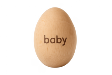 Wooden egg with baby text announcing pregnancy