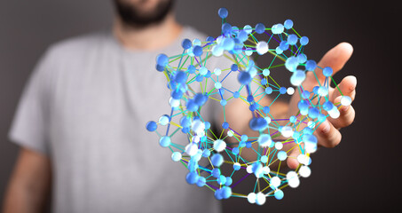 A man holding a 3D digital sphere symbolizing a network, connections, data, and the concept of networking or communication.