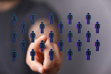 Hand pointing towards digital human icons, representing connection, unity, community, and social...