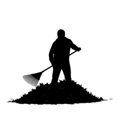 Silhouette of a man raking leaves into a pile.
