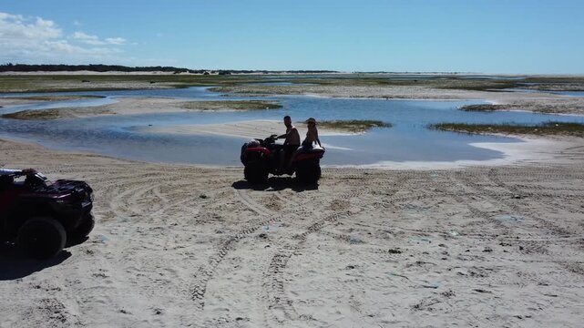 Aerial view of quad bike on sand dunes.