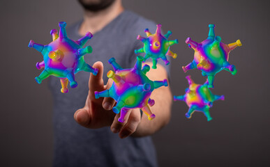 Creative abstract illustration depicting a human hand touching floating 3D rendered colorful coronavirus parti
