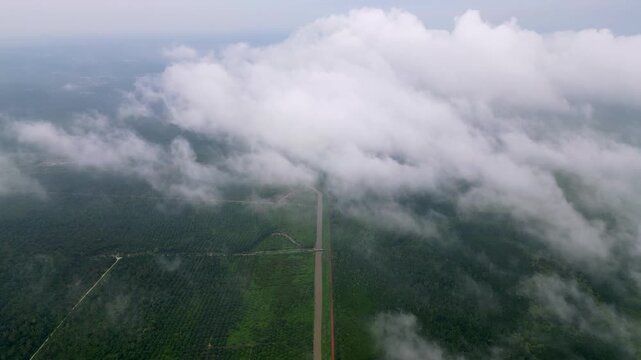 A cloudless sky with a few clouds. The sky is mostly blue with a few white clouds. Aerial Sungai Ayam, Batu Pahat
