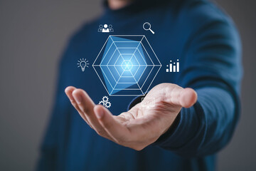 Business performance analysis concept with hand presenting radar chart and strategy icons. Data visualization, KPI measurement, market research, analytics, growth planning and decision making.