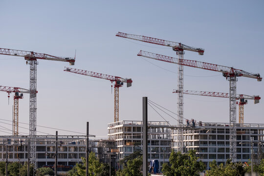 Wide skyline overview of construction site with tower crane and building development showing architecture urban engineering infrastructure property project