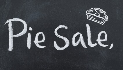 Handmade pie sale chalkboard sign with white bold writing and pie doodle for national pie day event closeup