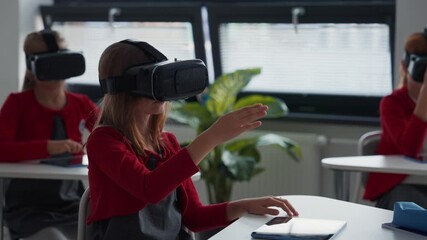 Elementary school students using virual reality in classroom. - Powered by Adobe
