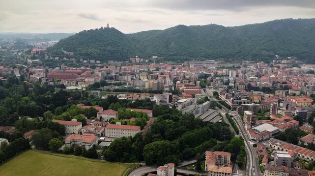 Drone flight over Como city - Baradello Tower and mountain landscape in Italy