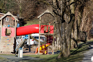 Colorful playground in a park with trees, inviting children to have fun and play