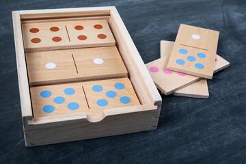 Wooden Domino Game Set In Storage Box On Dark Surface
