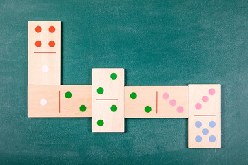 Wooden Domino Tiles Arranged In Cross Pattern On Green Background