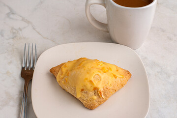 orange scone with a cup of coffee