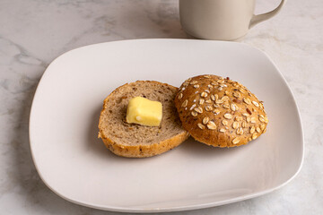 toasted multi grain bagel  with a slice of butter