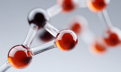 Close-up of transparent interconnected spheres filled with amber liquid.