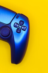 A gamepad for consoles on a yellow background, gaming addiction, gaming ban for teenagers, gaming controls for parents, for banners and advertising. High quality © Karen Vardanian