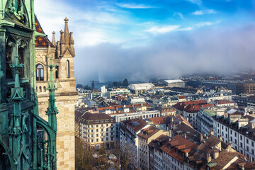 Obraz premium Elevated view from the Saint Pierre Cathedral in Geneva, Switzerland, of the city skyline during a foggy winter day with sunshine