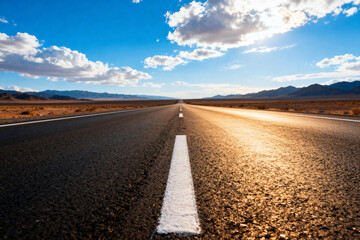 Endless Asphalt Road in Desert Under Blue Sky