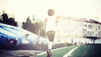Sports in the stadium. Sports Equipment. Warming up the player before the game. Child Game.