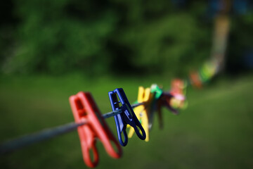 old pegs on a rope. One old retro clothespin wooden on a linen rope. Work on the house, washing, drying linen.