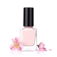 Pale pink nail polish bottle with a black cap, flowers around