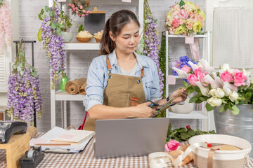 Florist shopkeeper small business owner preparing fresh roses at flower shop, daily work routine, floral arrangement, realistic retail workspace, independent local business scene, modern technology