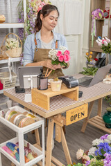 Florist shopkeeper startup small business owner arranging Valentine&rsquo;s Day flower orders, managing laptop workspace, growing branding, modern startup business lifestyle, woman working in floral shop