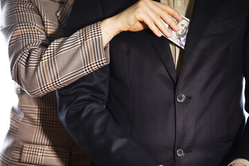 Businessmen secretly passing money - bribery and corruption concepts