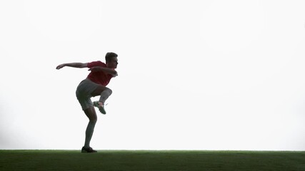 Powerful soccer side volley shot in mid air at white studio. Concept of match highlight content, goal scoring action, sports media usage, event promotion and football advertising visuals.