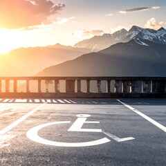 Parking space with a handicap symbol overlooking mountains at sunset
