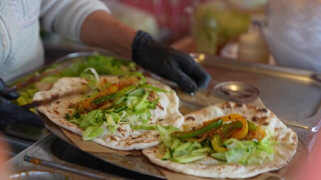 Preparing fresh fillings to be added into already cooked lachha parathas in a street food style setting