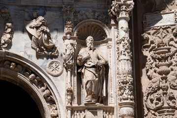 Intricate stone carvings and a prominent statue.. Collegiate Church of Santa María la Mayor, in...