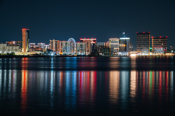 view of the nighttime city reflected in the water