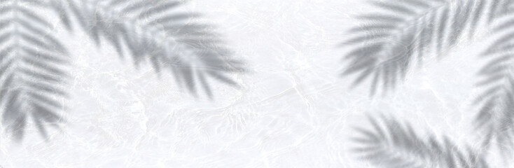 Water surface texture in white with blurred palm leaves shadow, creating a soft tropical atmosphere
