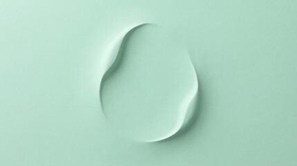 Top view of a single abstract organic shape with smooth curves and soft pastel green background creating a minimalist and clean aesthetic for design and branding