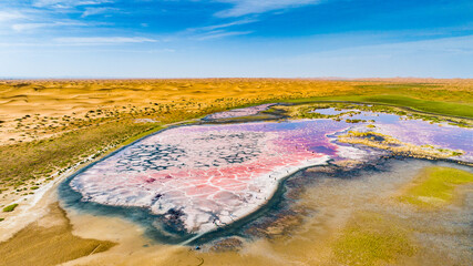 Colorful hypersaline ponds formed in the Tengger Desert, China, created by extreme evaporation,...
