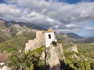 Fototapeta premium scenic cliff chapel captured from drone, stone chapel on rocky cliff with surrounding landscape
