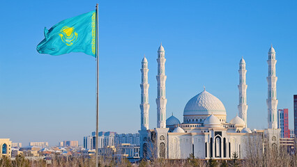 The flag of Kazakhstan is flying in the wind against the backdrop of the Hazret Sultan Mosque in Astana